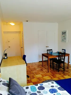 a living room with a table and a dining room at Stylish Montreal Apartment: Comfortable Stay in the Golden Square Mile in Montréal