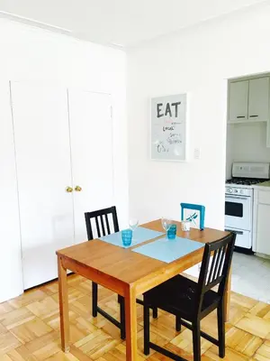 a kitchen with a wooden table and two chairs at Stylish Montreal Apartment: Comfortable Stay in the Golden Square Mile in Montréal