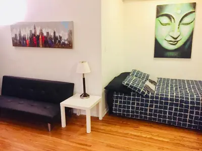 a living room with a bed and a couch at Stylish Montreal Apartment: Comfortable Stay in the Golden Square Mile in Montréal