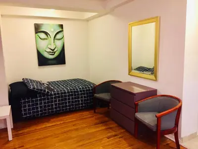 a room with a bed and a mirror at Stylish Montreal Apartment: Comfortable Stay in the Golden Square Mile in Montréal