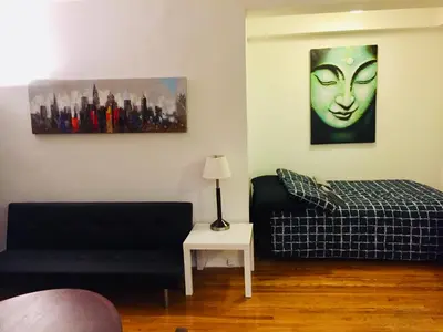 a living room with a couch and a bed at Stylish Montreal Apartment: Comfortable Stay in the Golden Square Mile in Montréal