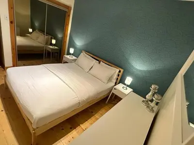 a bedroom with a large bed and a mirror at Best Monthly Deal - Plateau Apt - Top location in Montréal