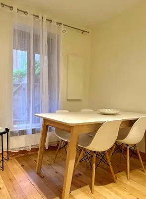 a table and chairs in a room with a window at Best Monthly Deal - Plateau Apt - Top location in Montréal