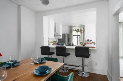 a kitchen and dining room with a wooden table and chairs at Luxurious Old Montreal Parking Patio 10 Guests in Montréal
