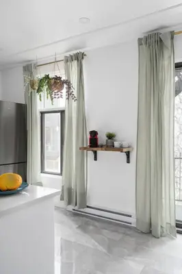 a room with white walls and windows with curtains at Luxurious Old Montreal Parking Patio 10 Guests in Montréal