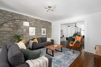 a living room with a couch and a stone wall at Luxurious Old Montreal Parking Patio 10 Guests in Montréal
