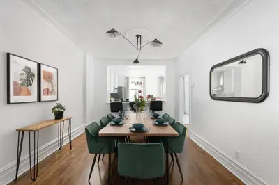 a dining room with a table and green chairs at Luxurious Old Montreal Parking Patio 10 Guests in Montréal