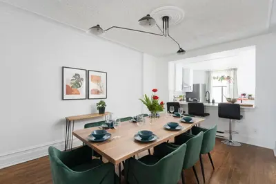 a dining room with a table and green chairs at Luxurious Old Montreal Parking Patio 10 Guests in Montréal