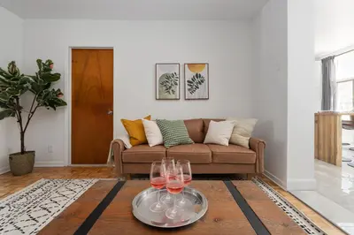 a living room with a couch and wine glasses on a table at Luxury Old Montreal Parking with Yard Patio 10 Guests in Montréal