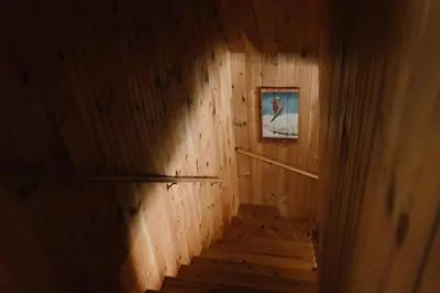 a hallway with wooden walls and stairs with a picture at Le Sunset in Eastman