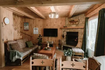 a living room with a couch and a fireplace at Le Sunset in Eastman