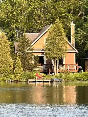 a house sitting on a dock on a body of water at Le Sunset in Eastman