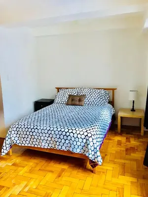 a bedroom with a bed with a teddy bear on it at Stylish Montreal Apartment: Comfortable Stay in the Golden Square Mile in Montréal