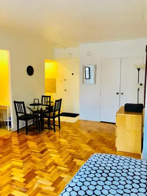 a dining room with a table and chairs on a wooden floor at Stylish Montreal Apartment: Comfortable Stay in the Golden Square Mile in Montréal