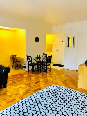 a room with a table and chairs and yellow walls at Stylish Montreal Apartment: Comfortable Stay in the Golden Square Mile in Montréal