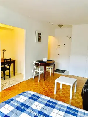 a living room with a table and chairs and a desk at Stylish Montreal Apartment: Comfortable Stay in the Golden Square Mile in Montréal