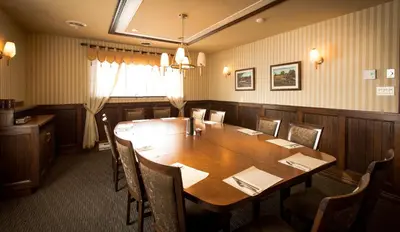 a dining room with a wooden table and chairs at Travelodge by Wyndham Drummondville in Drummondville