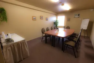 a conference room with a table and chairs at Travelodge by Wyndham Drummondville in Drummondville