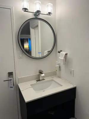 a bathroom with a sink and a mirror at Travelodge by Wyndham Drummondville in Drummondville