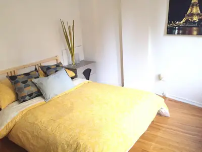 a bedroom with a bed with a yellow comforter at Stylish Montreal Apartment: Comfortable Stay in the Golden Square Mile in Montréal