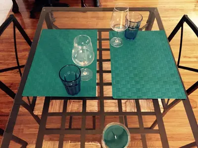 a green table with glasses on top of it at Stylish Montreal Apartment: Comfortable Stay in the Golden Square Mile in Montréal