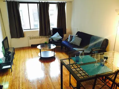 a living room with a couch and tables at Stylish Montreal Apartment: Comfortable Stay in the Golden Square Mile in Montréal