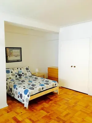 a bedroom with a bed and a wooden floor at Stylish Montreal Apartment: Comfortable Stay in the Golden Square Mile in Montréal