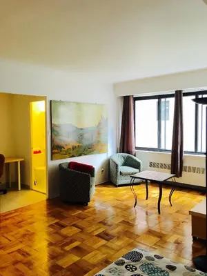 a living room with a couch and a table at Stylish Montreal Apartment: Comfortable Stay in the Golden Square Mile in Montréal