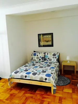 a bedroom with a bed with blue and white sheets at Stylish Montreal Apartment: Comfortable Stay in the Golden Square Mile in Montréal