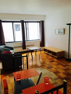 a living room with a couch and a table at Stylish Montreal Apartment: Comfortable Stay in the Golden Square Mile in Montréal