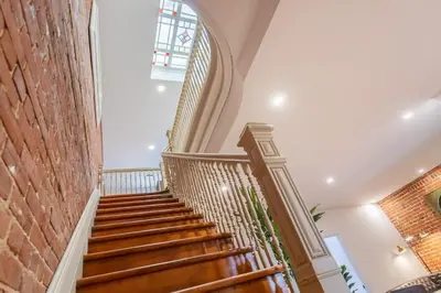 a staircase in a building with a brick wall at L'exclusif du Plateau in Montréal