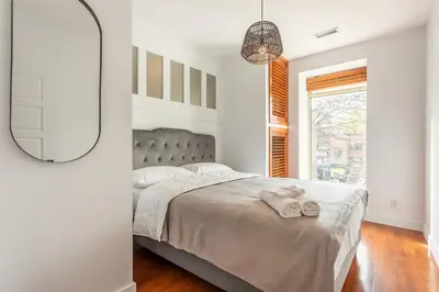 a bedroom with a bed with two towels on it at L'exclusif du Plateau in Montréal