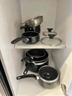 a kitchen with pots and pans on shelves at Appartment 2BR 4 beds AC wi-Fi Smart TV FreeParking in Laval