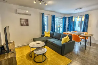 a living room with a couch and a table at Peaceful Getaway in Laval