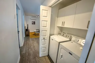 a kitchen with a washer and dryer in a room at Peaceful Getaway in Laval