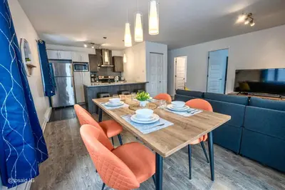 a kitchen and dining room with a table and chairs at Peaceful Getaway in Laval