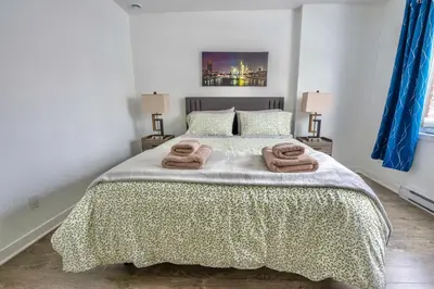 a bedroom with a bed with two towels on it at Peaceful Getaway in Laval