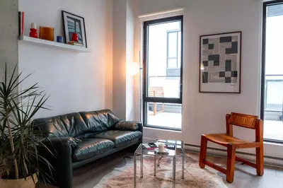 a living room with a leather couch and a table at Stuning penthouse old montreal in Montréal