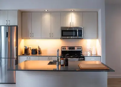 a kitchen with a sink and a stove top oven at Stuning penthouse old montreal in Montréal