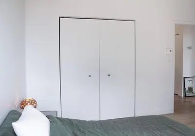 a bedroom with white cabinets and a bed at Stuning penthouse old montreal in Montréal