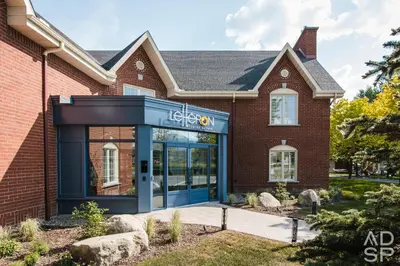a store front of a brick building at Le Héron - Studios Nature in Magog-Orford