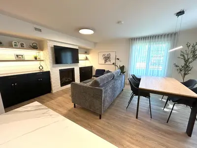 a living room with a couch and a table at Le Héron - Studios Nature in Magog-Orford