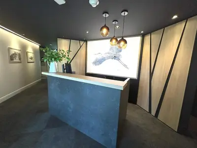 a lobby with a large painting on the wall at Le Héron - Studios Nature in Magog-Orford