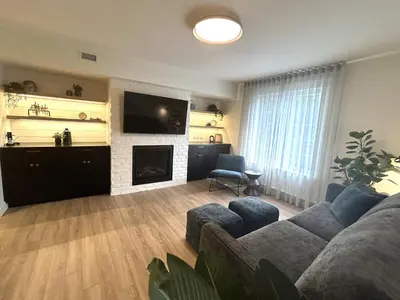 a living room with a couch and a fireplace at Le Héron - Studios Nature in Magog-Orford