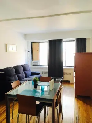 a living room with a table and a couch at Stylish Montreal Apartment Comfortable Stay in the Golden Square Mile in Montréal