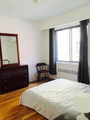 a bedroom with a bed and a mirror and a dresser at Stylish Montreal Apartment Comfortable Stay in the Golden Square Mile in Montréal