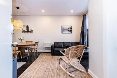 a living room with a table and a couch at Appartement Sur la 