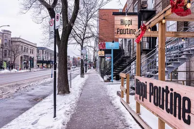 a snowy street with a sign for a hotel future at Appartement Sur la 