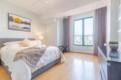 a bedroom with a bed and a large window at Appartement Sur la 