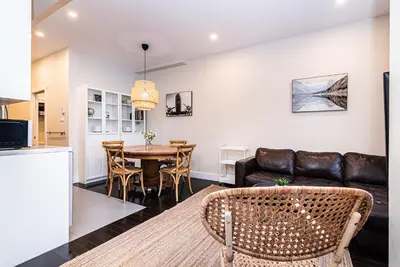 a living room with a couch and a table at Appartement Sur la 